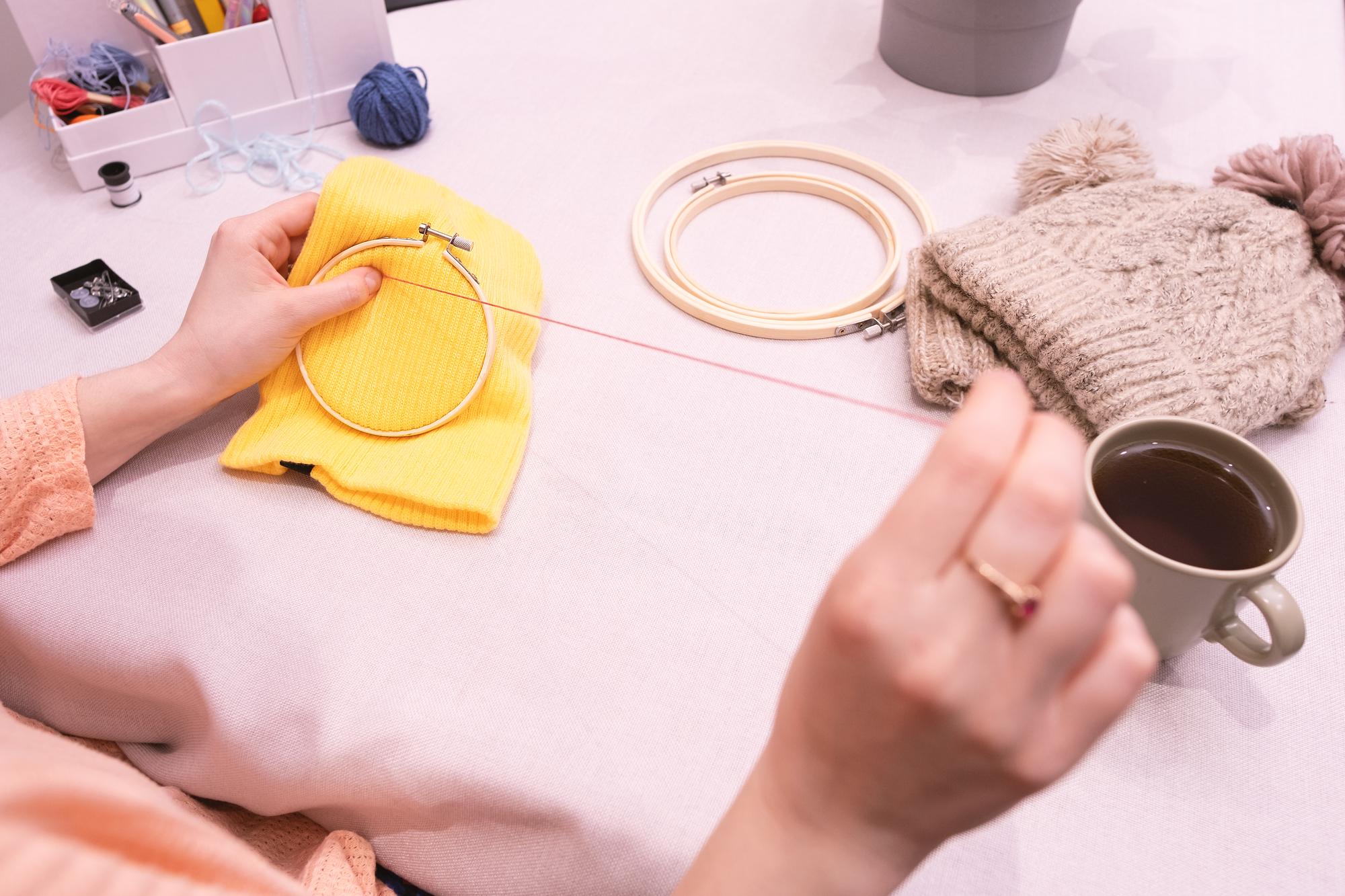 artisan embroiderer working at table with tools